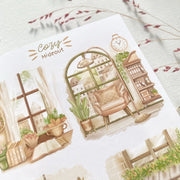 Premium Handmade Sticker Sheet Cozy Hideout 105mm x 148mm - 4 pieces on the table with a pink flower branch