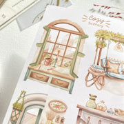 Premium Handmade Sticker Sheet Cozy Scenery 105mm x 148mm - 4 pieces on the table with dark maroon flower branch