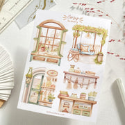 Premium Handmade Sticker Sheet Cozy Scenery 105mm x 148mm - 4 pieces on the table with dark maroon flower branch