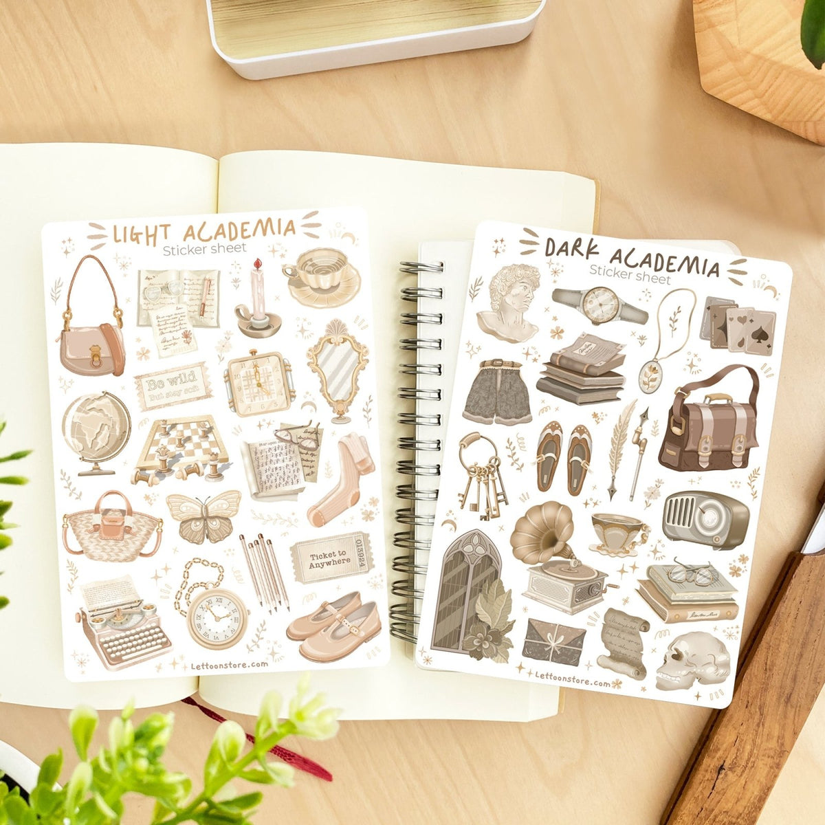 Premium Handmade Sticker Sheet Dark & Light Academia 105mm x 148mm - 2 sheets on the table with a plant branch, an opened notebook, a ruler