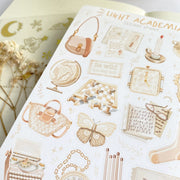 Premium Handmade Sticker Sheet Dark & Light Academia 105mm x 148mm - a sheet on the table with an opened notebook, a white flower branch