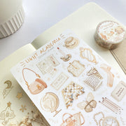 Premium Handmade Sticker Sheet Dark & Light Academia 105mm x 148mm - a washi tape and a sheet on the table with an opened notebook, a white flower branch
