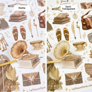 Premium Handmade Sticker Sheet Dark & Light Academia 105mm x 148mm - 2 different sheets on the table with an opened notebook