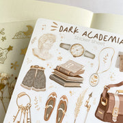 Premium Handmade Sticker Sheet Dark & Light Academia 105mm x 148mm - a sheet on the table with an opened notebook