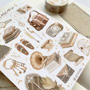 Premium Handmade Sticker Sheet Dark & Light Academia 105mm x 148mm - a washi tape and a sheet on the table with an opened notebook