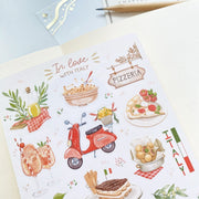 Premium Handmade Sticker Sheet In Love With Italy 105mm x 148mm - a sheet on the table with an opened notebook, a pencil
