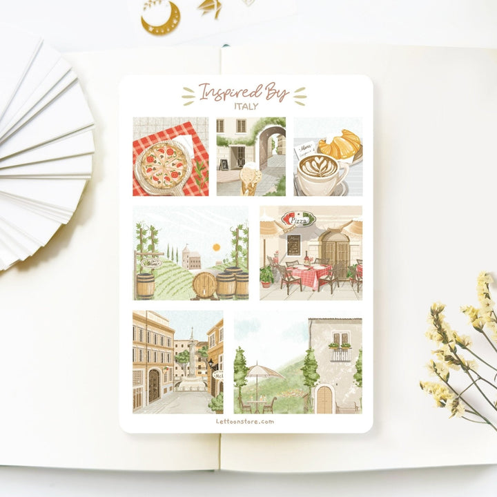 Premium Handmade Sticker Sheet Inspired by Italy 105mm x 148mm - a sheet on the table with a white flower branch, an opened notebook