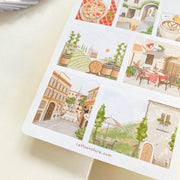 Premium Handmade Sticker Sheet Inspired by Italy 105mm x 148mm - a sheet on the table with an opened notebook