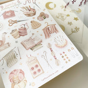 Premium Handmade Sticker Sheet Knitting Crochet 105mm x 148mm - a sheet on the table with an opened notebook
