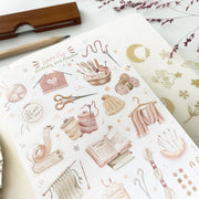 Premium Handmade Sticker Sheet Knitting Crochet 105mm x 148mm - a sheet on the table with a dark maroon flower branch, an opened notebook,  a pencil, a ruler