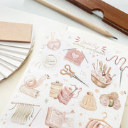Premium Handmade Sticker Sheet Knitting Crochet 105mm x 148mm - a sheet on the table with a pencil, an opened notebook, a ruler