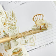 Premium Handmade Sticker Sheet Magical Cozy Fall 105mm x 148mm - 3 pieces and a sheet on the table with an opened notebook