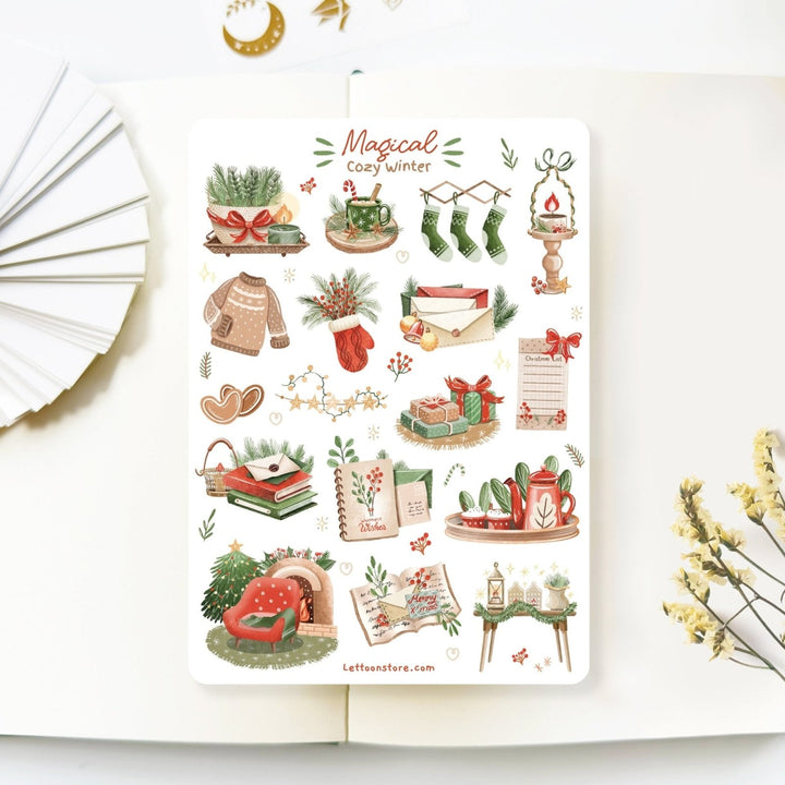 Premium Handmade Sticker Sheet Magical Cozy Winter 105mm x 148mm - a sheet on the table with a white flower branch, an opened notebook
