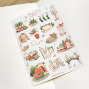 Premium Handmade Sticker Sheet Magical Cozy Winter 105mm x 148mm - a sheet on the table with an opened notebook