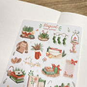 Premium Handmade Sticker Sheet Magical Cozy Winter 105mm x 148mm - a sheet on the table with an opened notebook