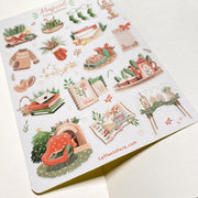 Premium Handmade Sticker Sheet Magical Cozy Winter 105mm x 148mm - a sheet on the table with an opened notebook