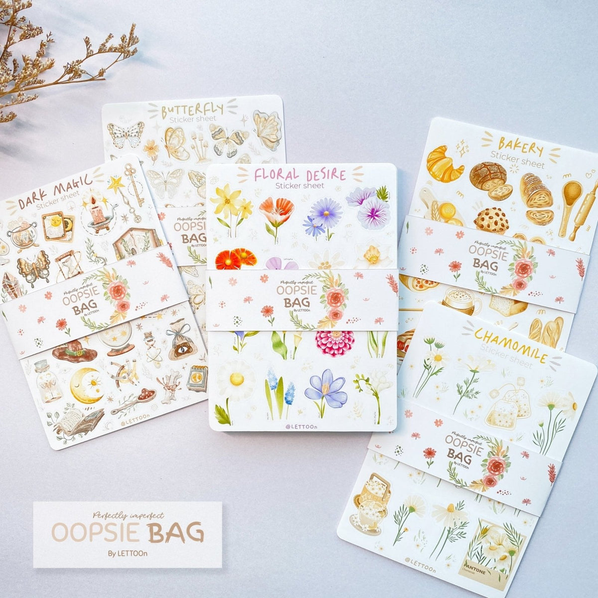 Premium Handmade Sticker Sheet Mystery Oopsie Bag - 5 sheets on the table with a white branch