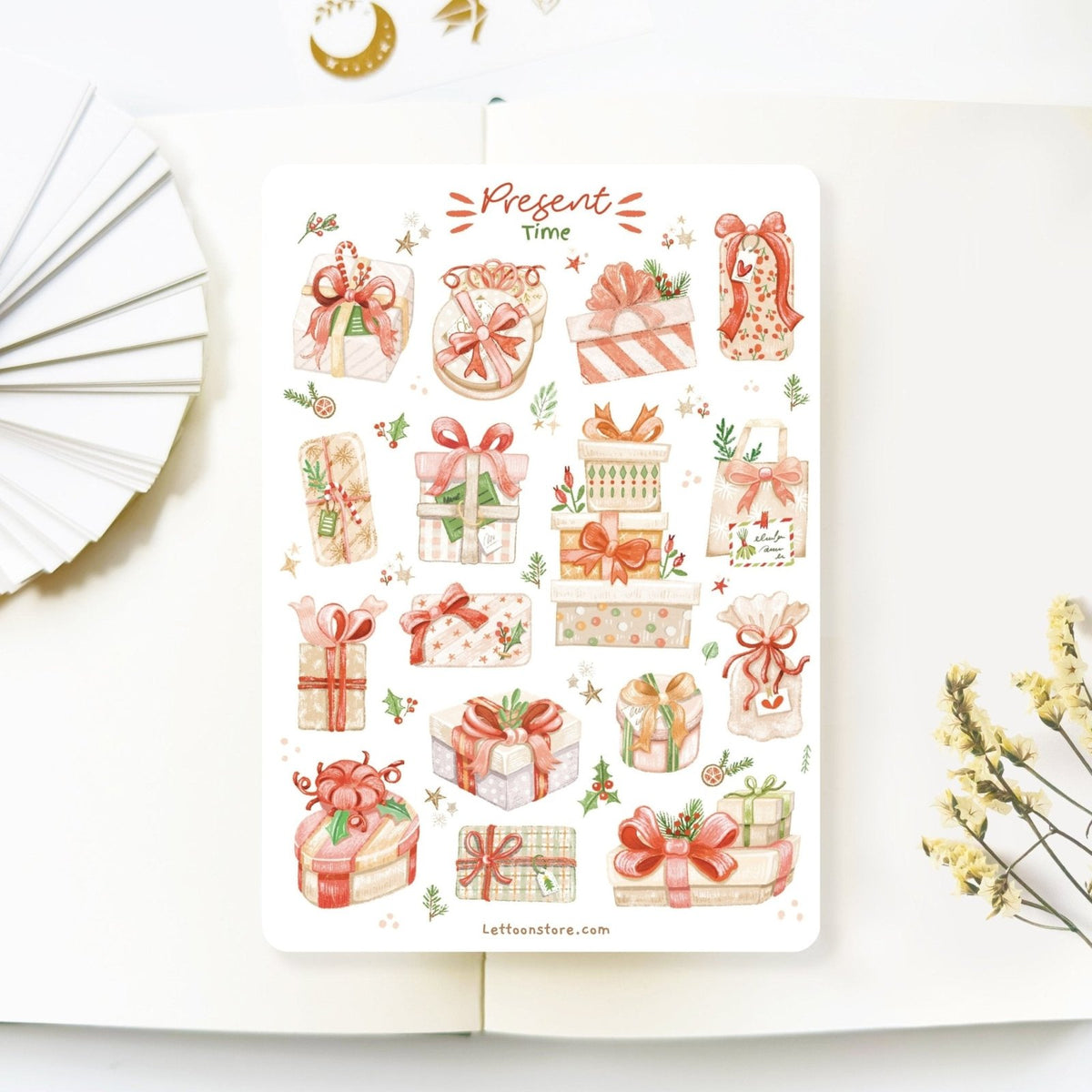 Premium Handmade Sticker Sheet Present Time 105mm x 148mm - a sheet on the table with a white flower branch, an opened notebook