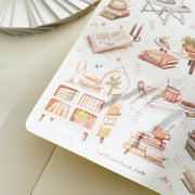 Premium Handmade Sticker Sheet Reading at Home 105mm x 148mm - a sheet on the table with an opened notebook
