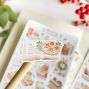Premium Handmade Sticker Sheet 
Reading in the Winter 105mm x 148mm - a piece and a sheet on the table with a branch, a red berry branch