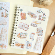 Premium Handmade Sticker Sheet Reading Time 105mm x 148mm - a sheet and 11 pieces on the table with a white flower branch, an opened notebook