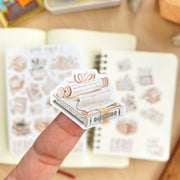 Premium Handmade Sticker Sheet Reading Time 105mm x 148mm - a piece and 2 sheets on the table with an opened notebook in the background