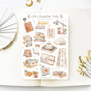 Premium Handmade Sticker Sheet Reading Time 105mm x 148mm - a sheet on the table with a white flower branch, an opened notebook