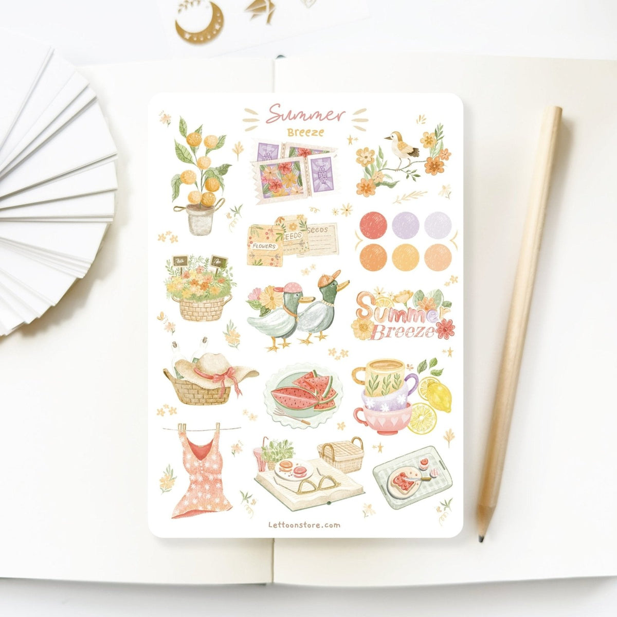 Premium Handmade Sticker Sheet Summer Breeze 105mm x 148mm - a sheet on the table with a pencil, an opened notebook