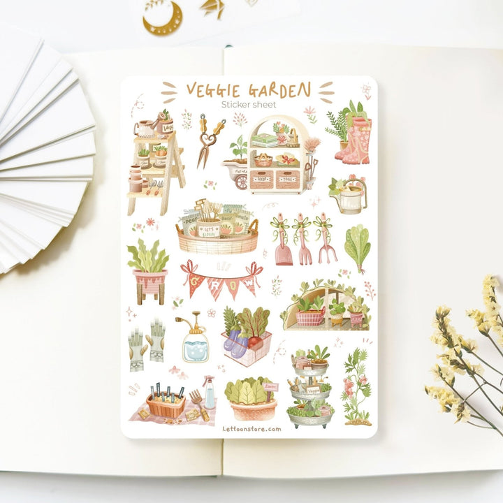 Premium Handmade Sticker Sheet 
Veggie Garden 105mm x 148mm - a sheet on the table with a white flower branch, an opened notebook