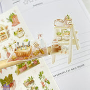 Premium Handmade Sticker Sheet 
Veggie Garden 105mm x 148mm - 2 pieces and a sheet on the table with an opened notebook