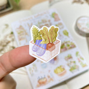 Premium Handmade Sticker Sheet 
Veggie Garden 105mm x 148mm - a piece and a sheet on the table with a white flower branch, an opened notebook, a washi tape