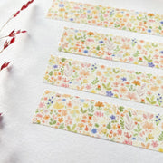 Premium Handmade Washi Tape Blooming Flower 15mm x 10m - 4 pieces on the table with a dark maroon branch