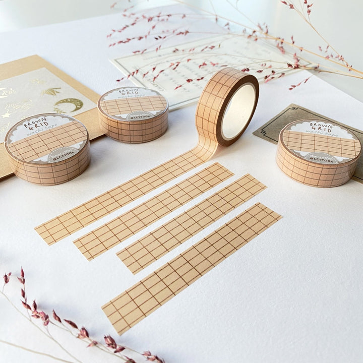 Premium Handmade Washi Tape Brown Grid 15mm x 10m - 4 pieces and 4 washi tapes on the table with 2 dark maroon flower branches, a chapter heading, a sticker sheet