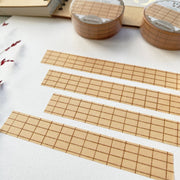 Premium Handmade Washi Tape Brown Grid 15mm x 10m - 4 pieces and 2 washi tapes on the table with a dark maroon flower branch, a notebook