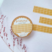 Premium Handmade Washi Tape Butterscotch Grid 15mm x 10m - 3 pieces and a washi tape on the table with a dark maroon flower branch