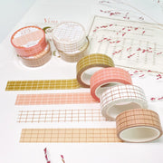 Premium Handmade Washi Tape 
Gridtastic 15mm x 10m - 4 pieces and 8 washi tapes on the table with a dark maroon flower branch, a chapter heading, a sticker sheet