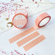 Premium Handmade Washi Tape Peach Grid 15mm x 10m - 3 pieces and 3 washi tapes on the table with 2 dark pink flower branches, a chapter heading, a sticker sheet