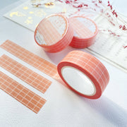 Premium Handmade Washi Tape Peach Grid 15mm x 10m - 3 pieces and 3 washi tapes on the table with 
a dark pink flower branch, a chapter heading, a sticker sheet