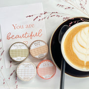 Premium Handmade Washi Tape Peach Grid 15mm x 10m - 4 washi tapes on the table with 
2 dark pink flower branches, a cup of latte, a spoon