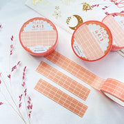 Premium Handmade Washi Tape Peach Grid 15mm x 10m - 3 pieces and 4 washi tapes on the table with 
a dark pink flower branch, a sticker sheet