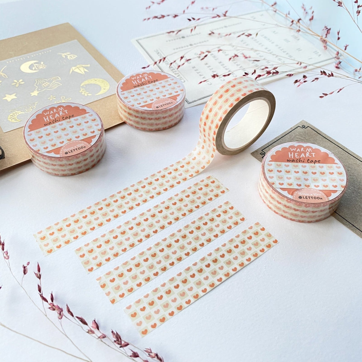 Premium Handmade Washi Tape Warm Heart 15mm x 10m - 4 pieces and 4 washi tapes on the table with 2 dark maroon flower branches, a sticker sheet, a chapter heading