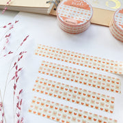 Premium Handmade Washi Tape Warm Heart 15mm x 10m - 4 pieces and 2 washi tapes on the table with a dark maroon flower branch, a sticker sheet, a notebook