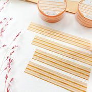 Premium Handmade Washi Tape Warm Line 15mm x 10m - 4 pieces and 2 washi tapes on the table with a dark maroon flower branch