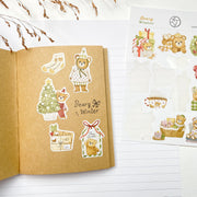 Beary Winter stickers in a kraft notebook: a bear with a gift, a Christmas tree and a bear with a bow