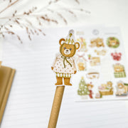 Beary Winter kiss-cut sticker on a pencil: a bear in a green bow and a polka-dot dress