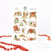 Slow Winter Christmas sticker sheet, A6: hands in knitted cuffs lighting a candle, tying a bow and sealing a letter