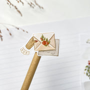 Slow Winter kiss-cut sticker on a pencil: hands holding a sealed envelope