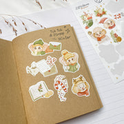 Tuk Tuk and Stroop Winter stickers in a kraft notebook: Tuk Tuk, Stroop, a candy cane and a letter