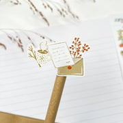 Tuk Tuk and Stroop Winter kiss-cut sticker on a pencil: a cup of cocoa with a letter and berries