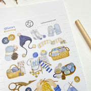 Close-up of Winter Knitting kiss-cut stickers on matte paper: yarn balls and stork scissors